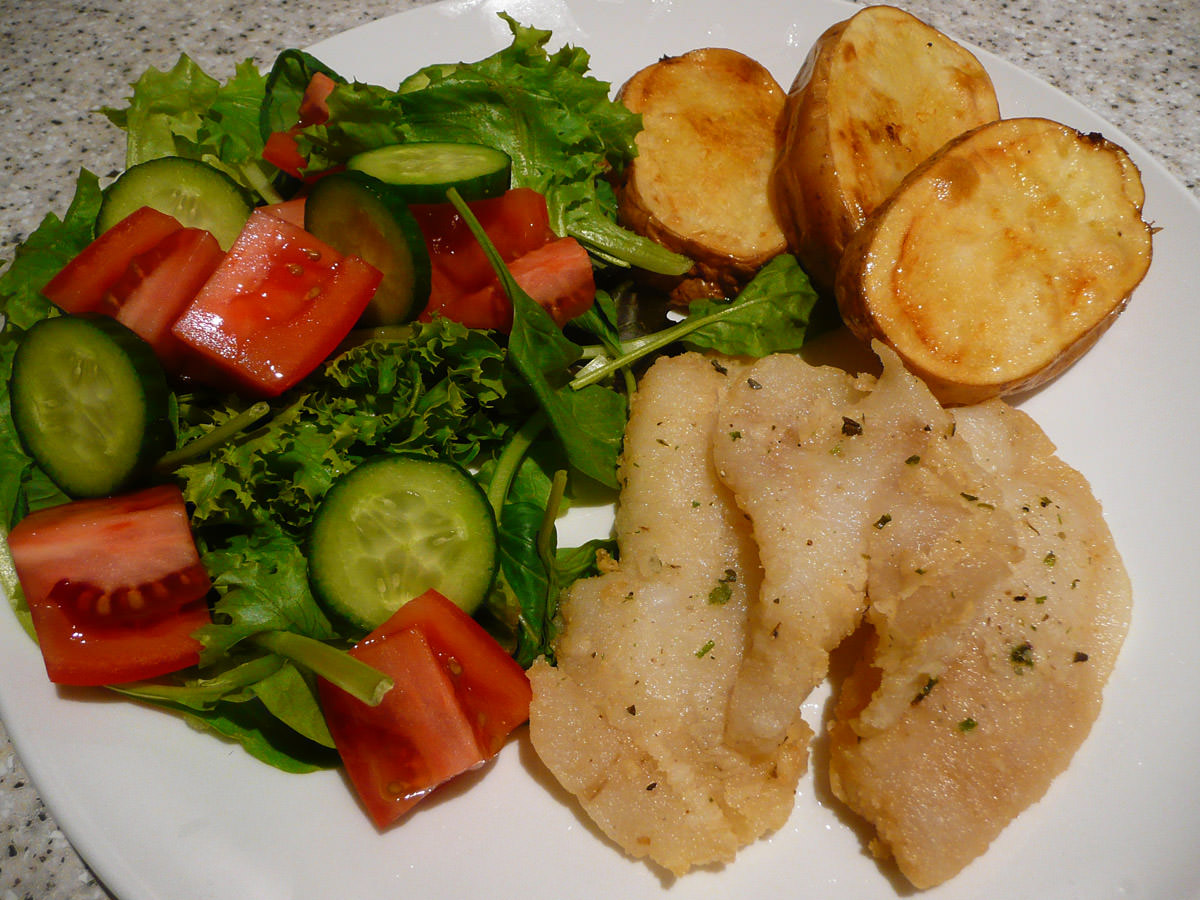 Fried fish, salad and potatoes