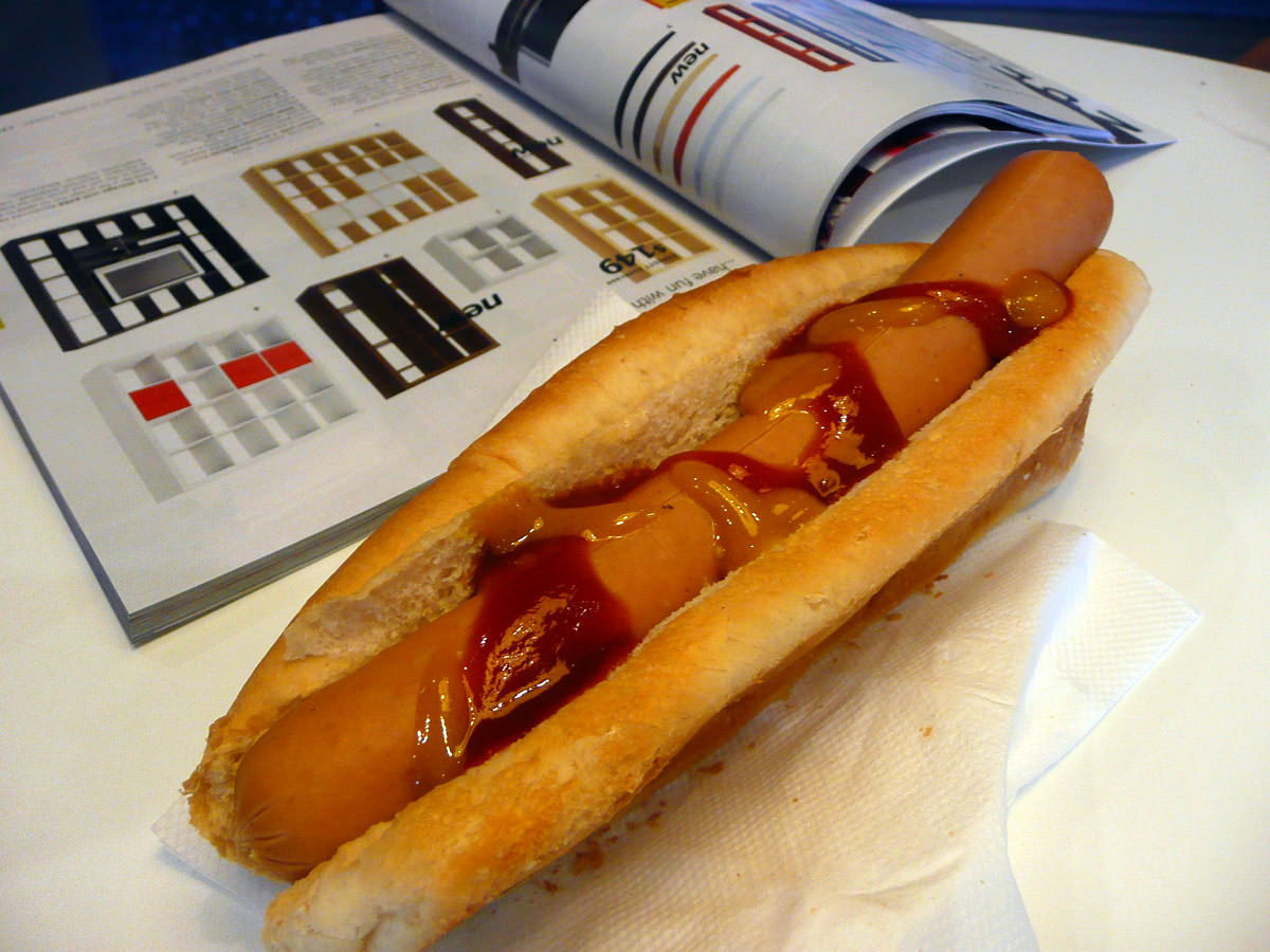Jac is reading the IKEA catalogue while I photograph my hot dog