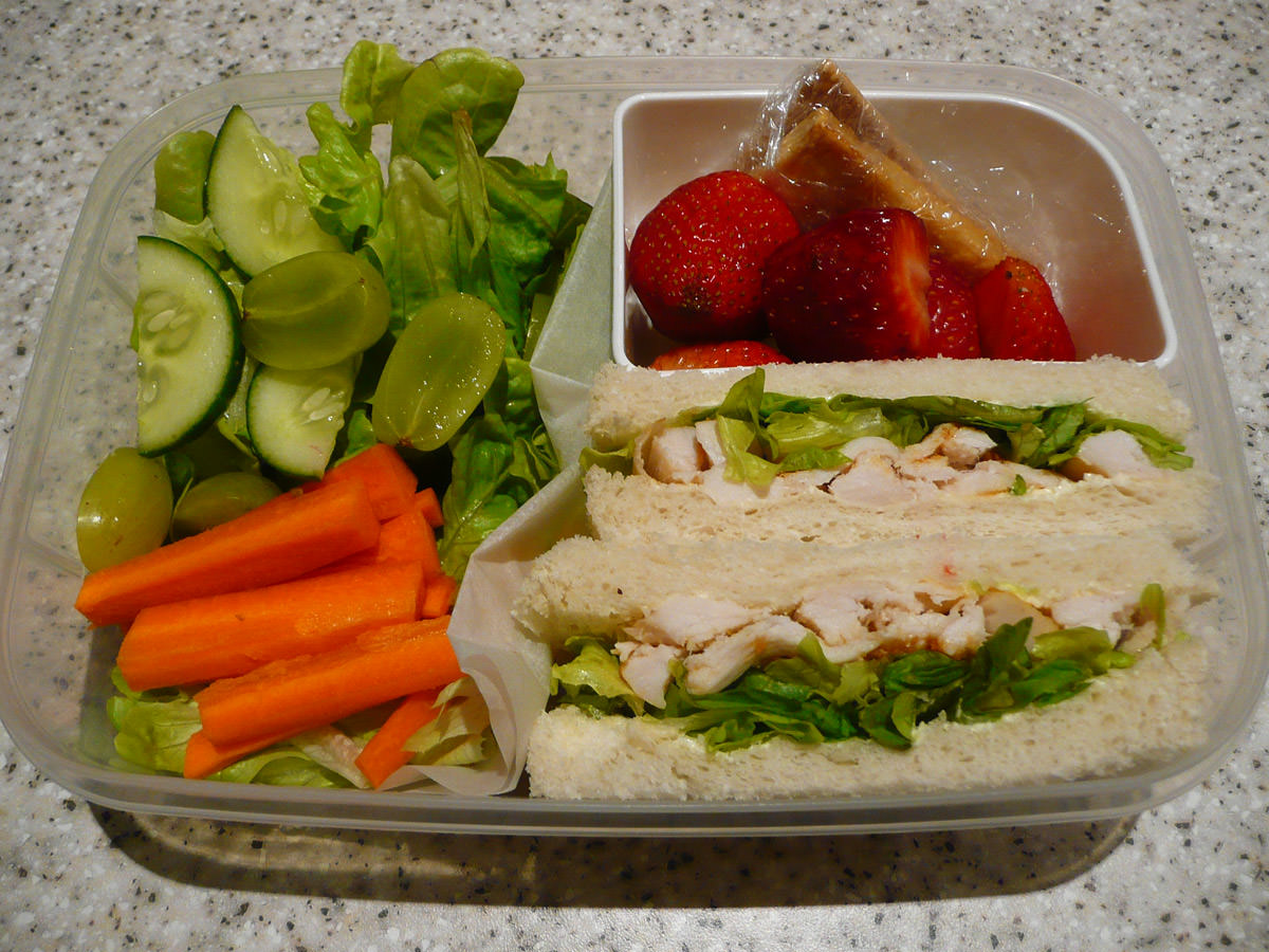 My bento lunch - Thai red curry chicken sandwiches, salad, strawberries and sweet crackers
