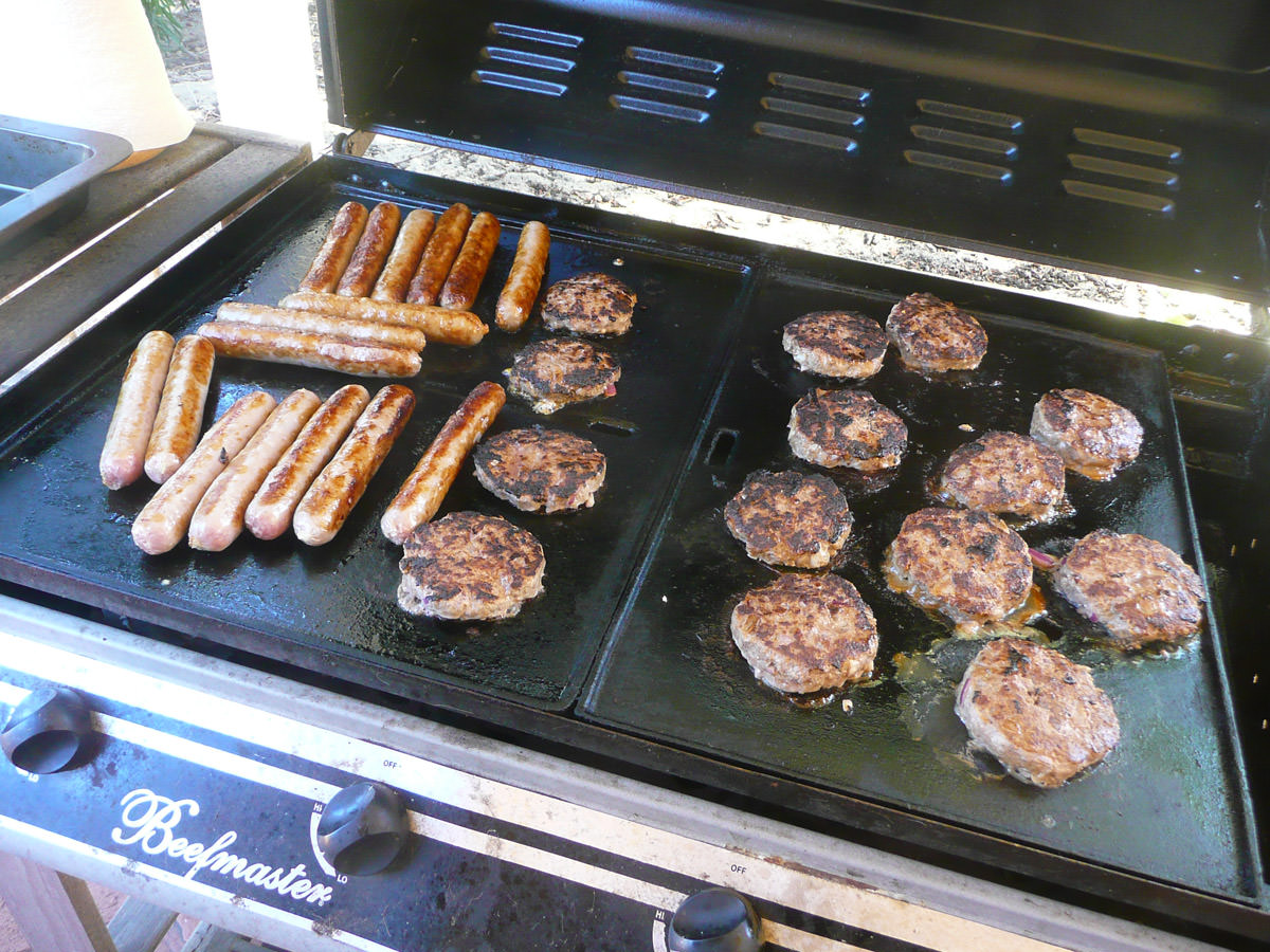 Burger patties and sausages on the barbecue
