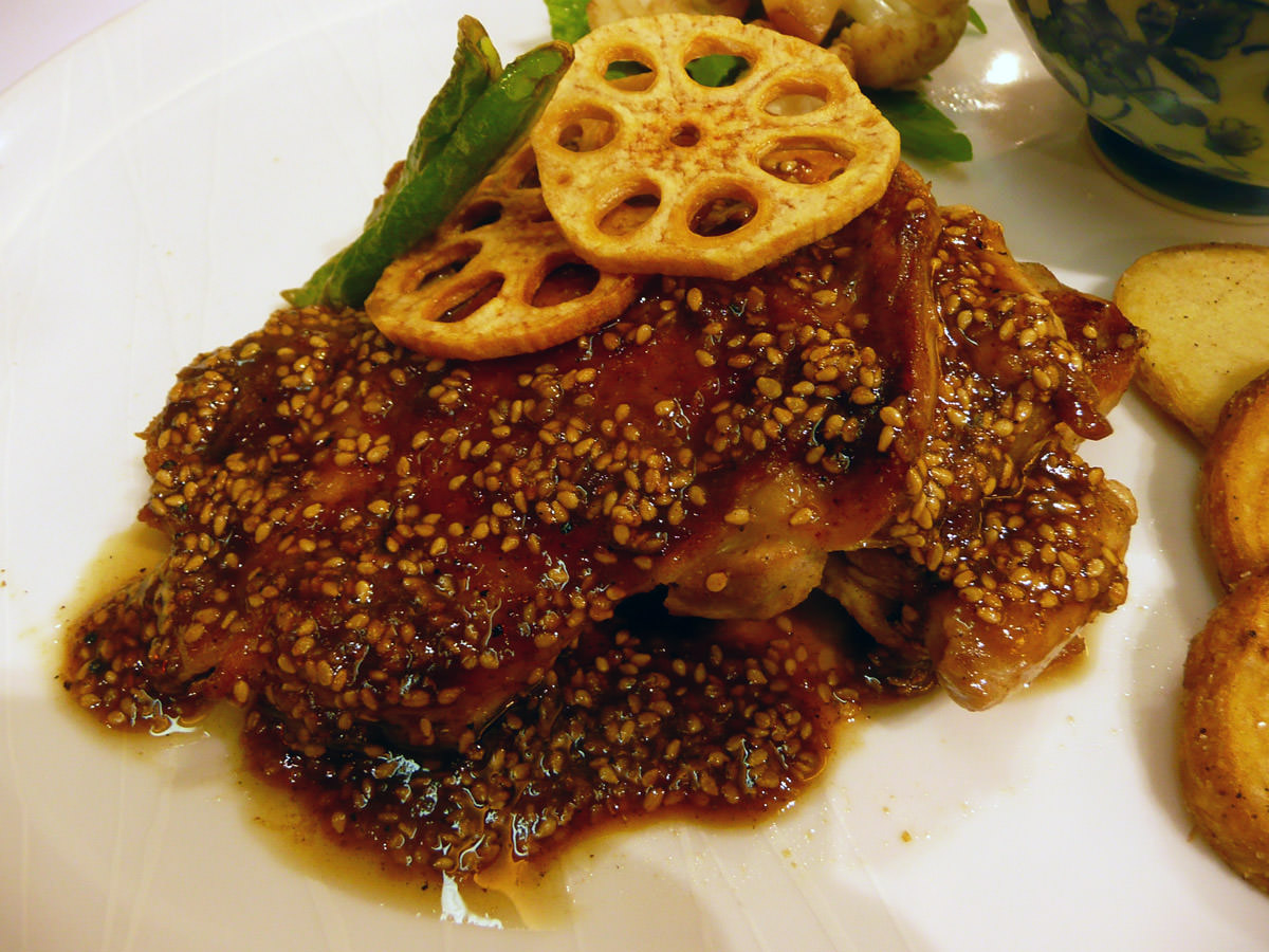Grilled chicken thighs with sesame and miso sauce topped with fried lotus root