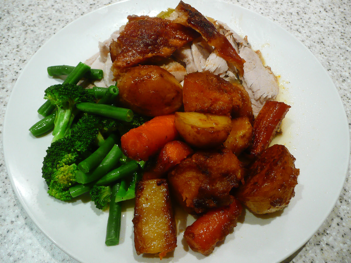 Roast pork with roasted root vegetables and steamed green vegetables