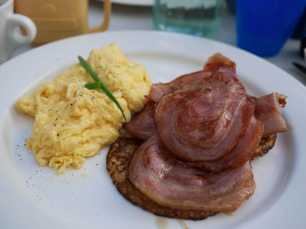 Corn fritters and bacon with maple syrup, with scrambled eggs