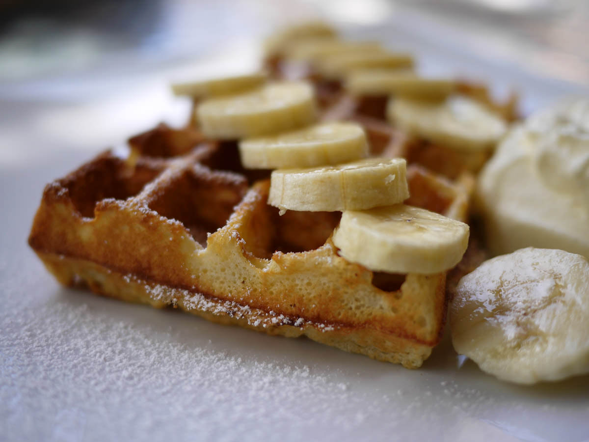 Waffle with banana and cream - close-up