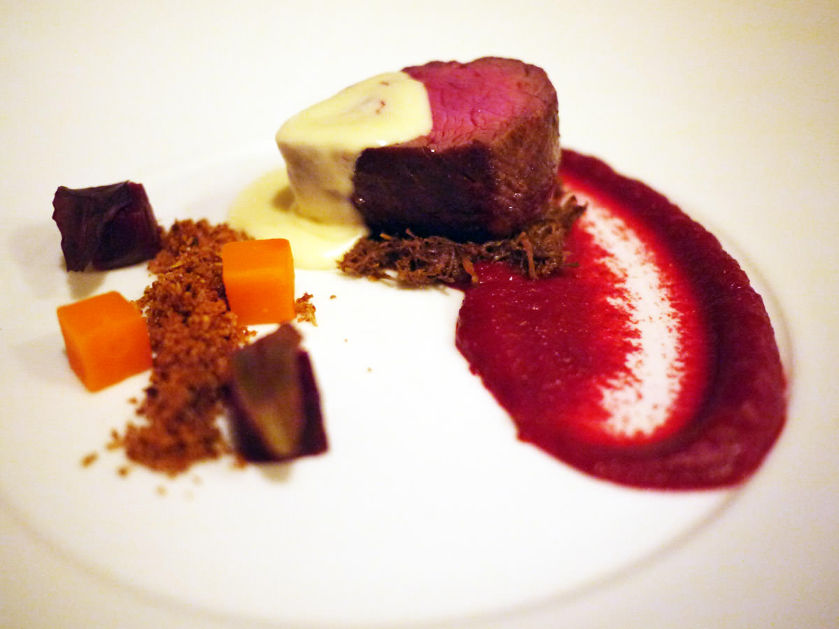 Third course: Beef eye fillet on braised beef cheek with beetroot puree, carrot and beetroot cubes, cauliflower crumble and blue cheese sauce