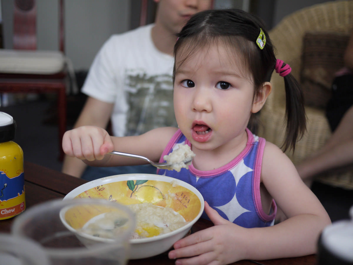 Zoe eating rice porridge