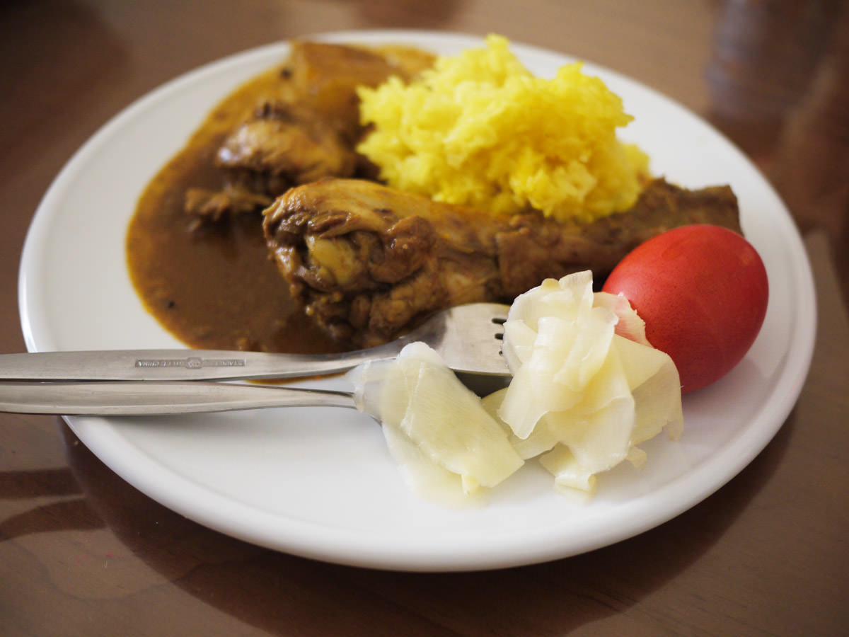 Jac's plate: Chicken curry, yellow rice, red egg and pickled ginger
