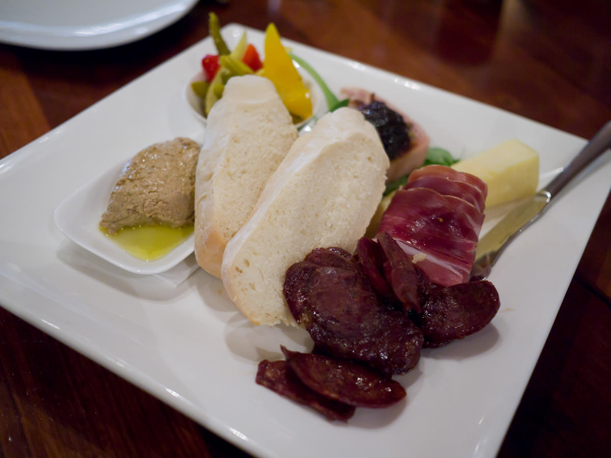 Tasting plate: pork and pistachio terrine, venison chorizo, duck liver pate, cheddar, baguette, home made pickles