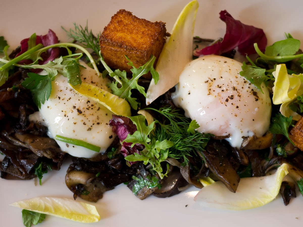 Wild mushrooms, slow cooked eggs and grilled polenta - close-up