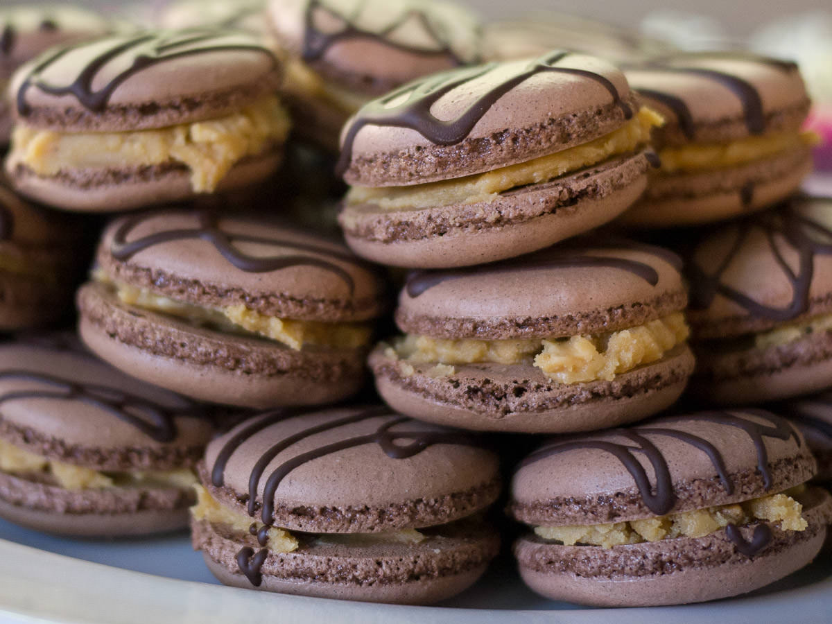 Chocolate macarons with white chocolate peanut butter ganache - close-up