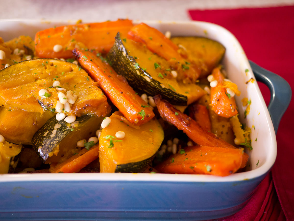 Roasted pumpkin and carrot sprinkled with pine nuts