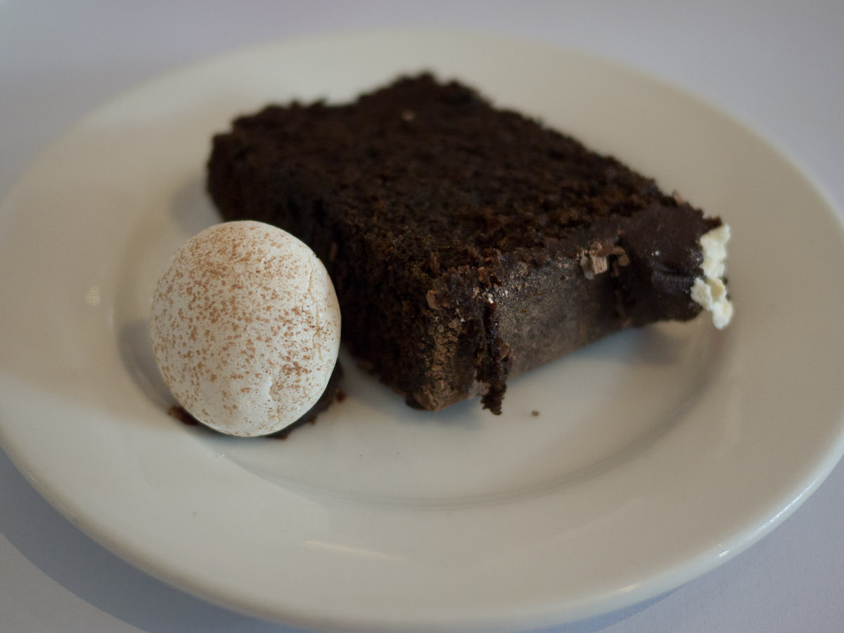 A piece of chocolate cake with a meringue mushroom
