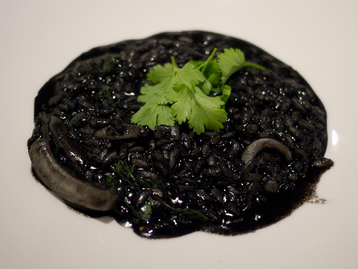 Squid and squid ink risotto with chilli, coriander and bacon