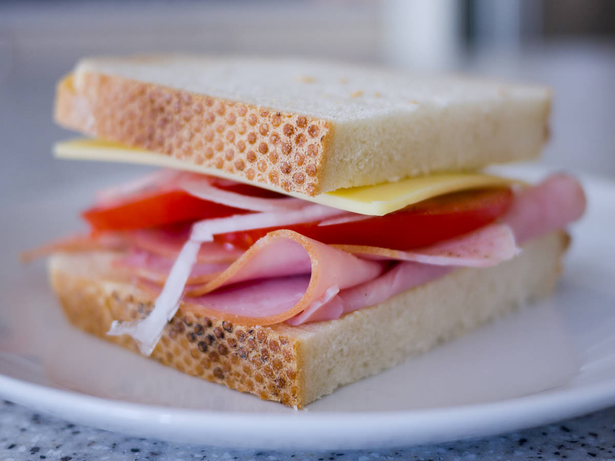 Ham, cheese, tomato and onion sandwich