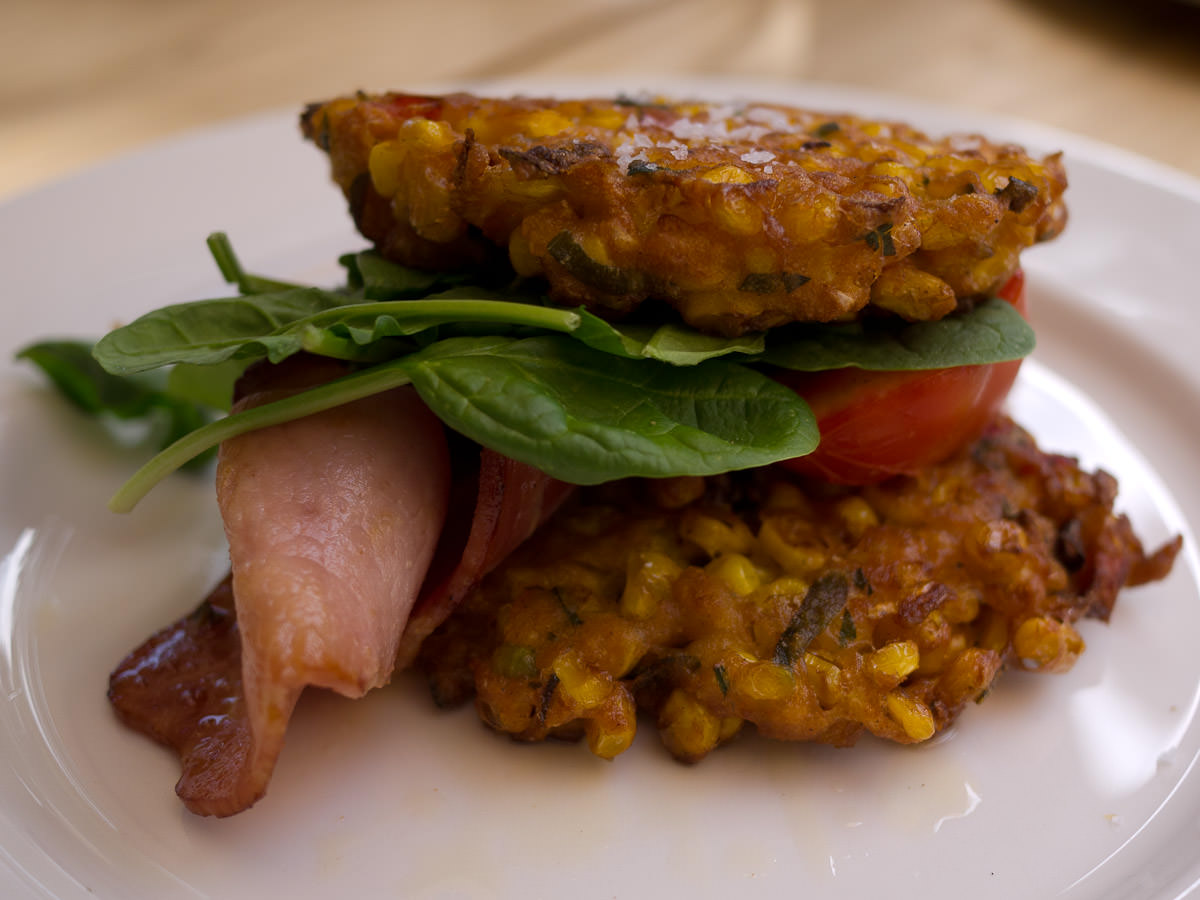 Sweet corn fritters with roast tomato, spinach and bacon (AU$18.50)