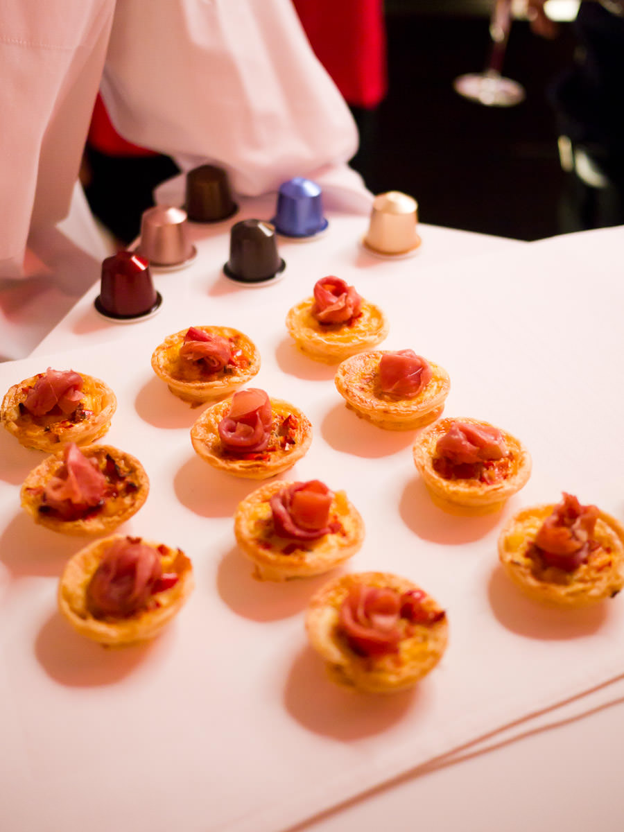 Red capsicum sofrito tart garnished with shaved prosciutto