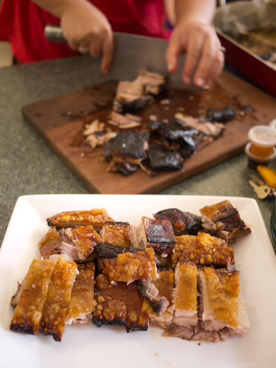 Chopping up the roasted pork belly