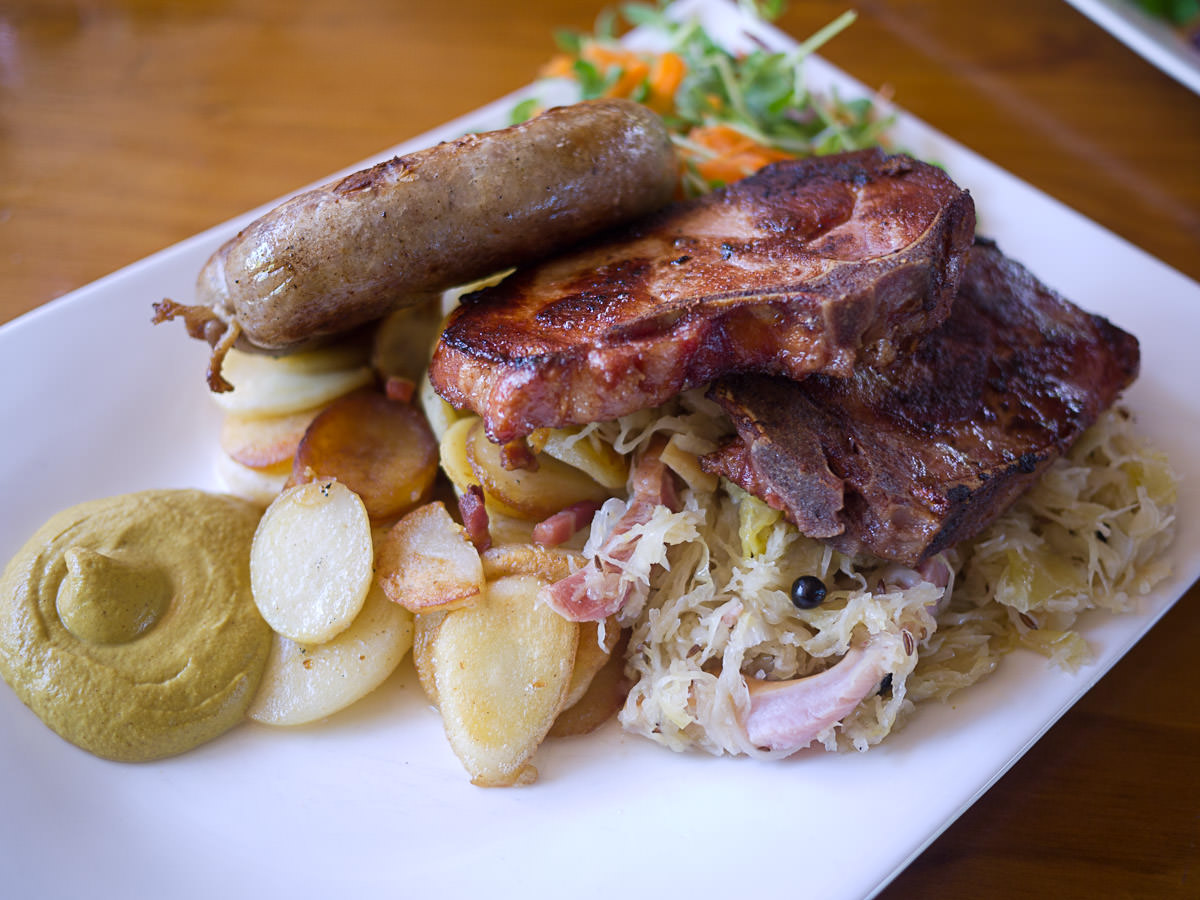 Grill plate - another angle: German bratwurst sausage and a smoked cutlet served with panfried potatoes and sauerkraut (AU$31.50)