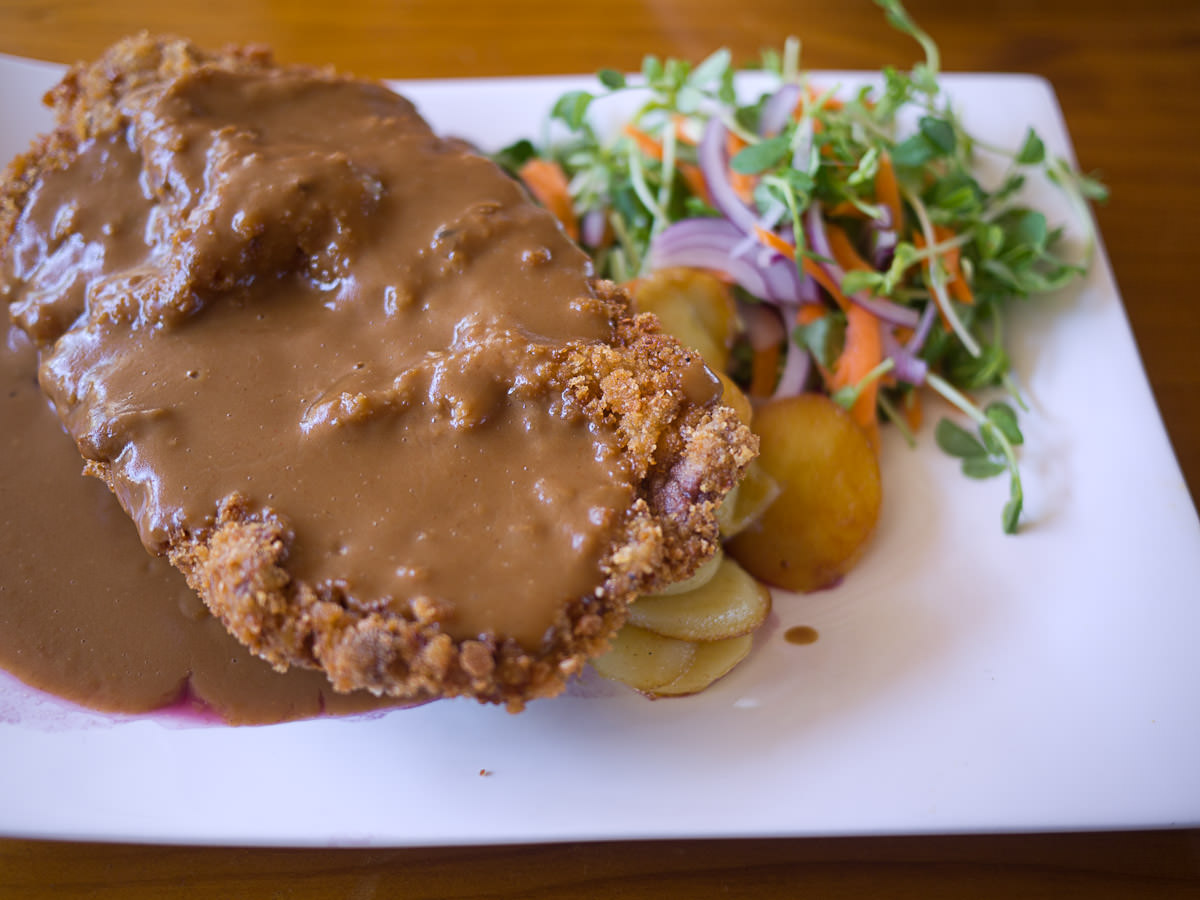 Veal schnitzel topped with creamy mushroom sauce served with red 
cabbage and pan fried potatoes (AU$31)