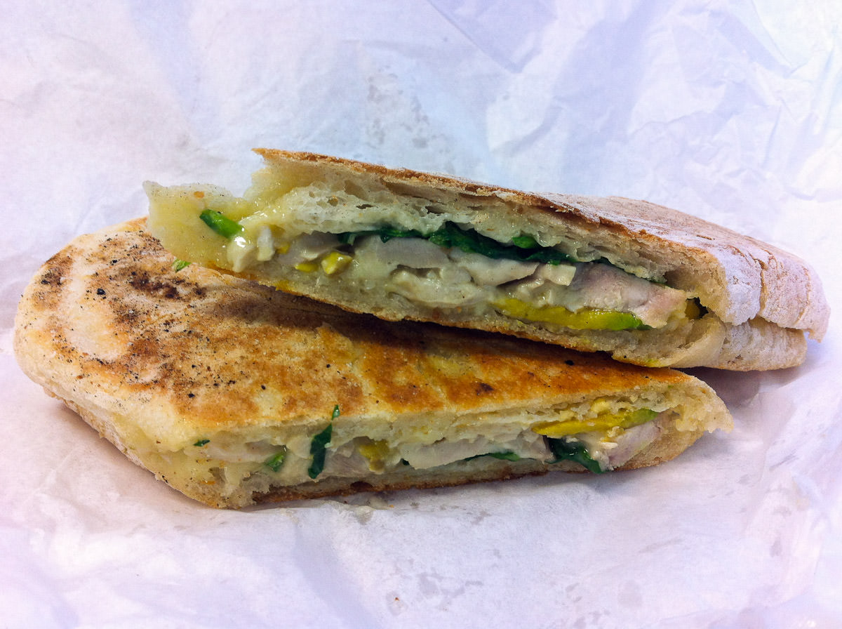Toasted panini with chicken, Brie, avocado and spinach