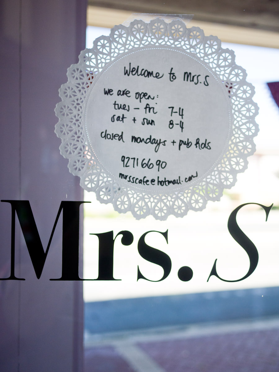 Mrs. S' contact details and opening hours are displayed on a doily