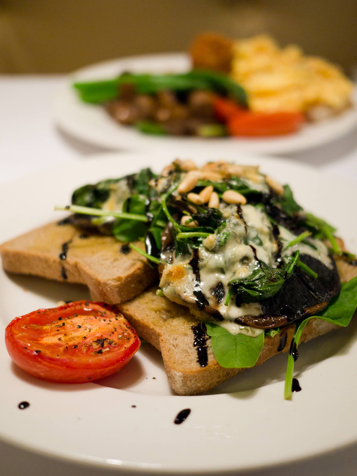 Grilled field mushrooms on rye with blue cheese, spinach, balsamic vinegar and roasted pine nuts (AU$18.10)