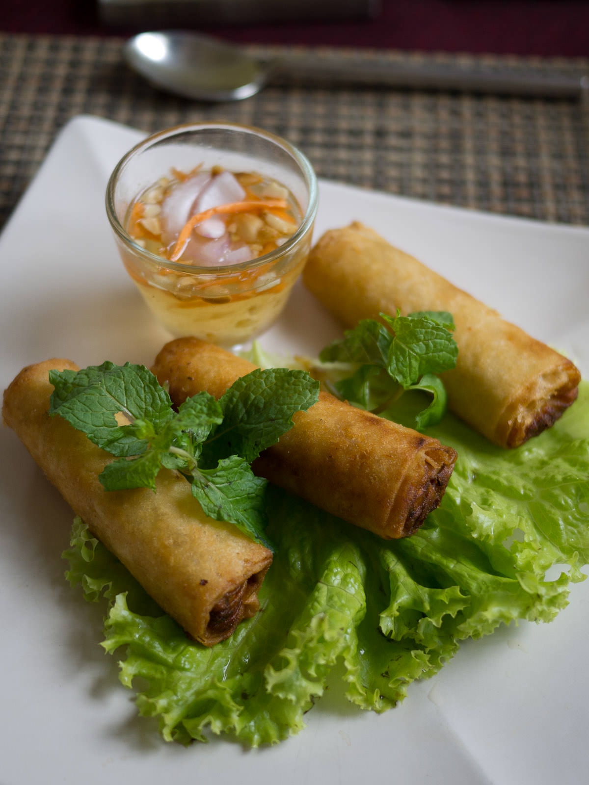 Deep fried spring rolls with chicken, fresh mint and vinegar sauce