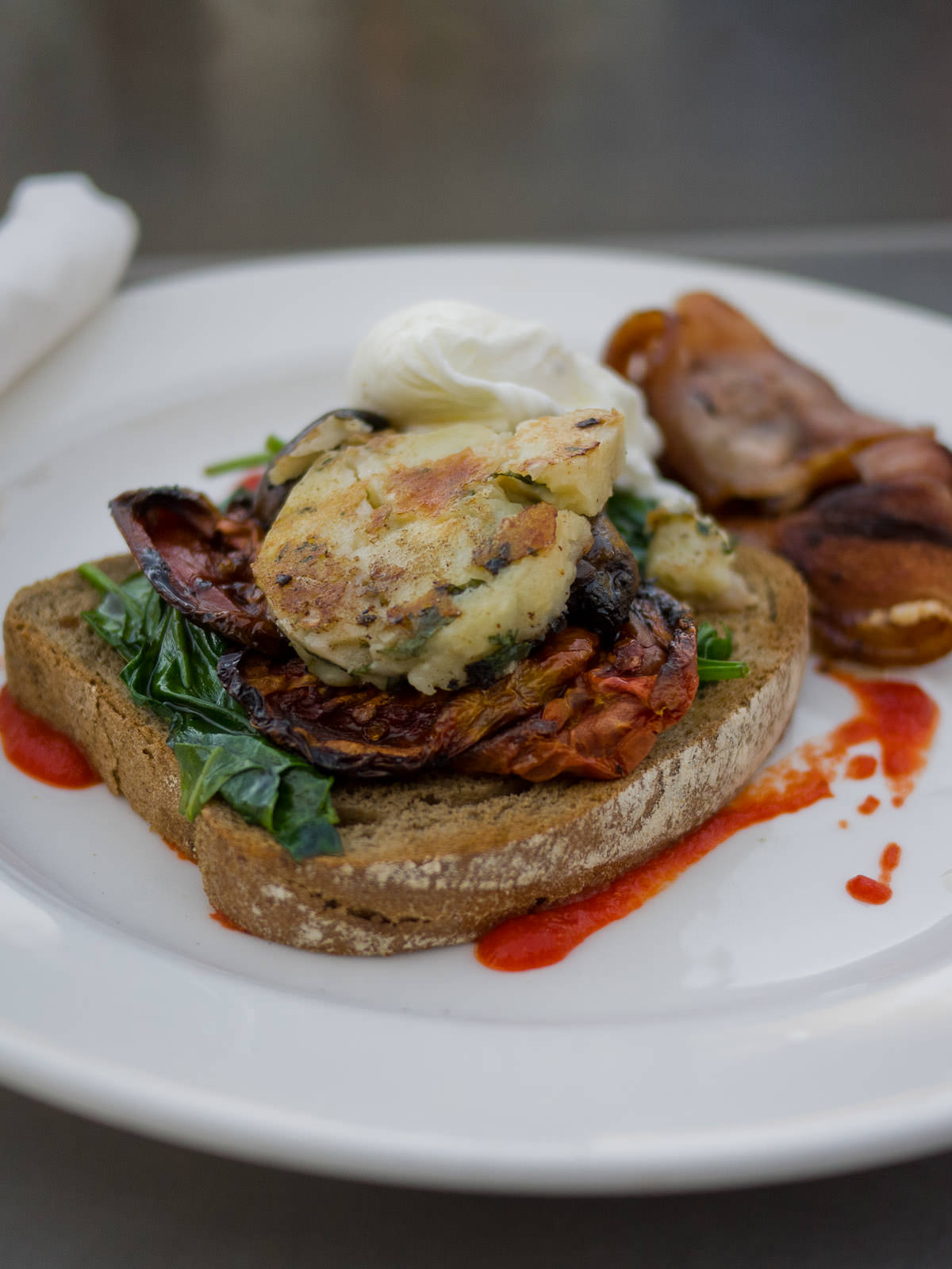 Vegetarian - toast, hash brown, mushroom, spinach, roast tomato and poached egg (AU$16) with a side of bacon (AU$4)