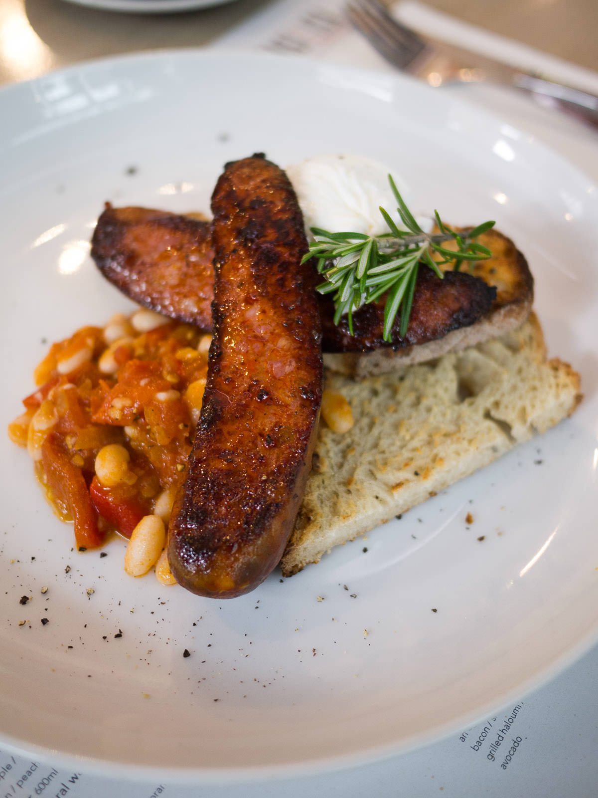 Grilled chorizo with cannellini beans, poached egg and sourdough (AU$17.50)