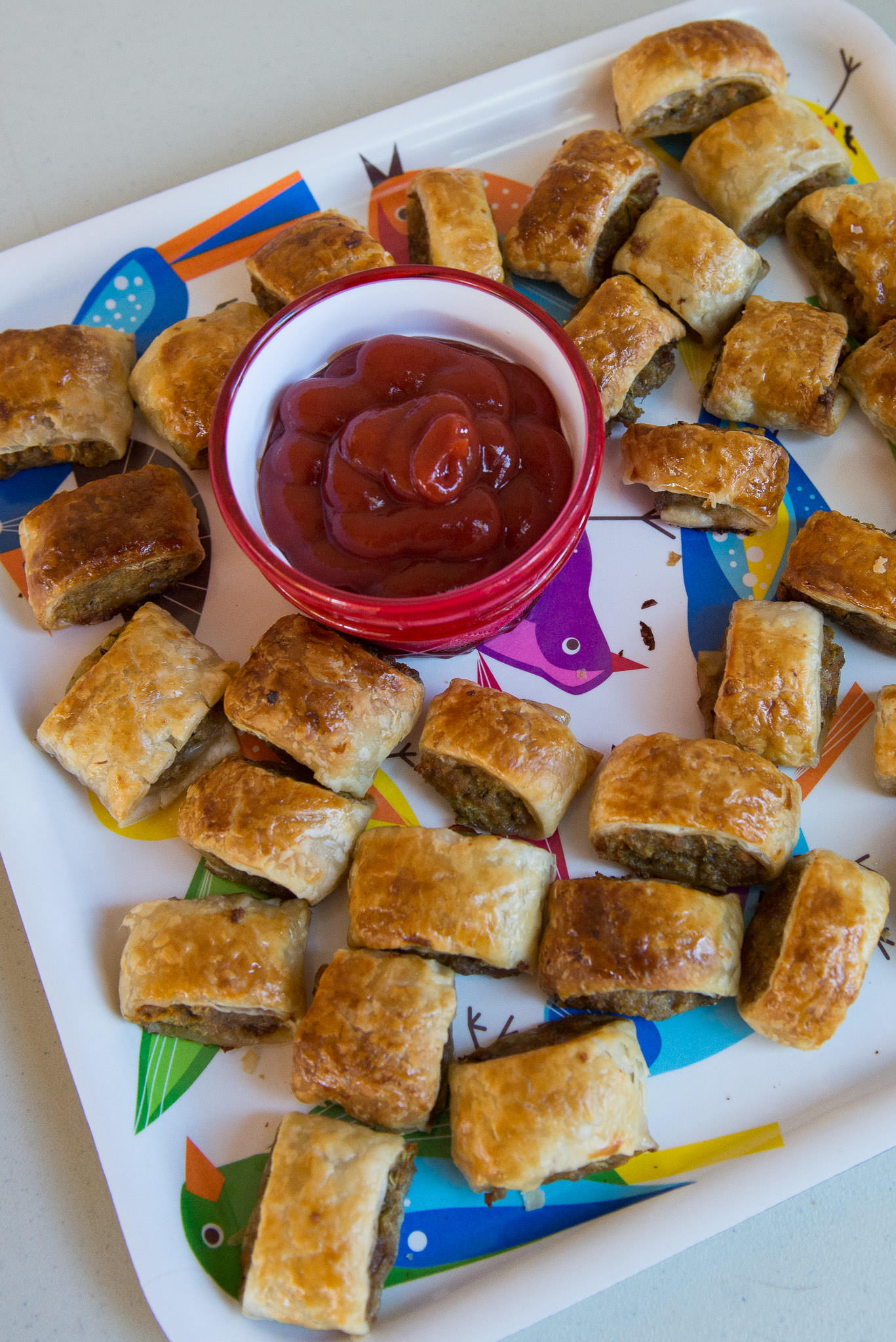 Party sausage rolls with tomato sauce