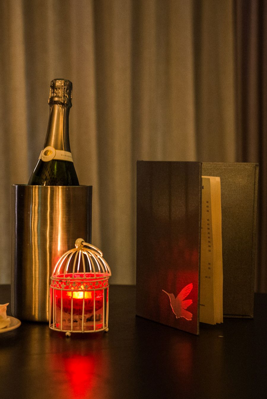 Champagne, lamp and menu - The Aviary