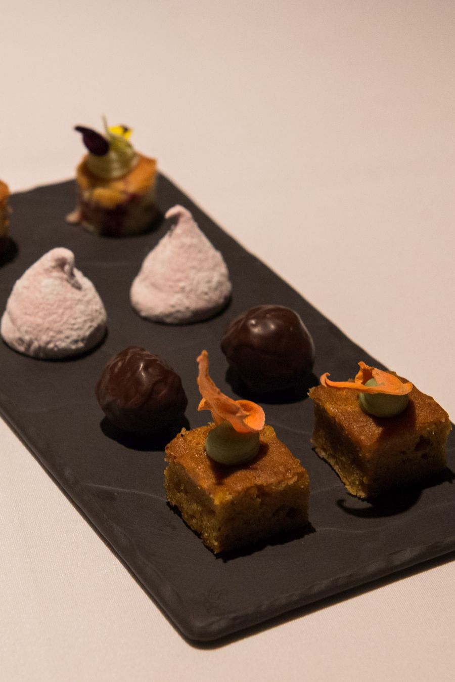 The 'things' served with coffee: carrot cake with dehydrated carrot and green tea ganache; Captain Morgan rum balls, marshmallow and white chocolate and raspberry torte 