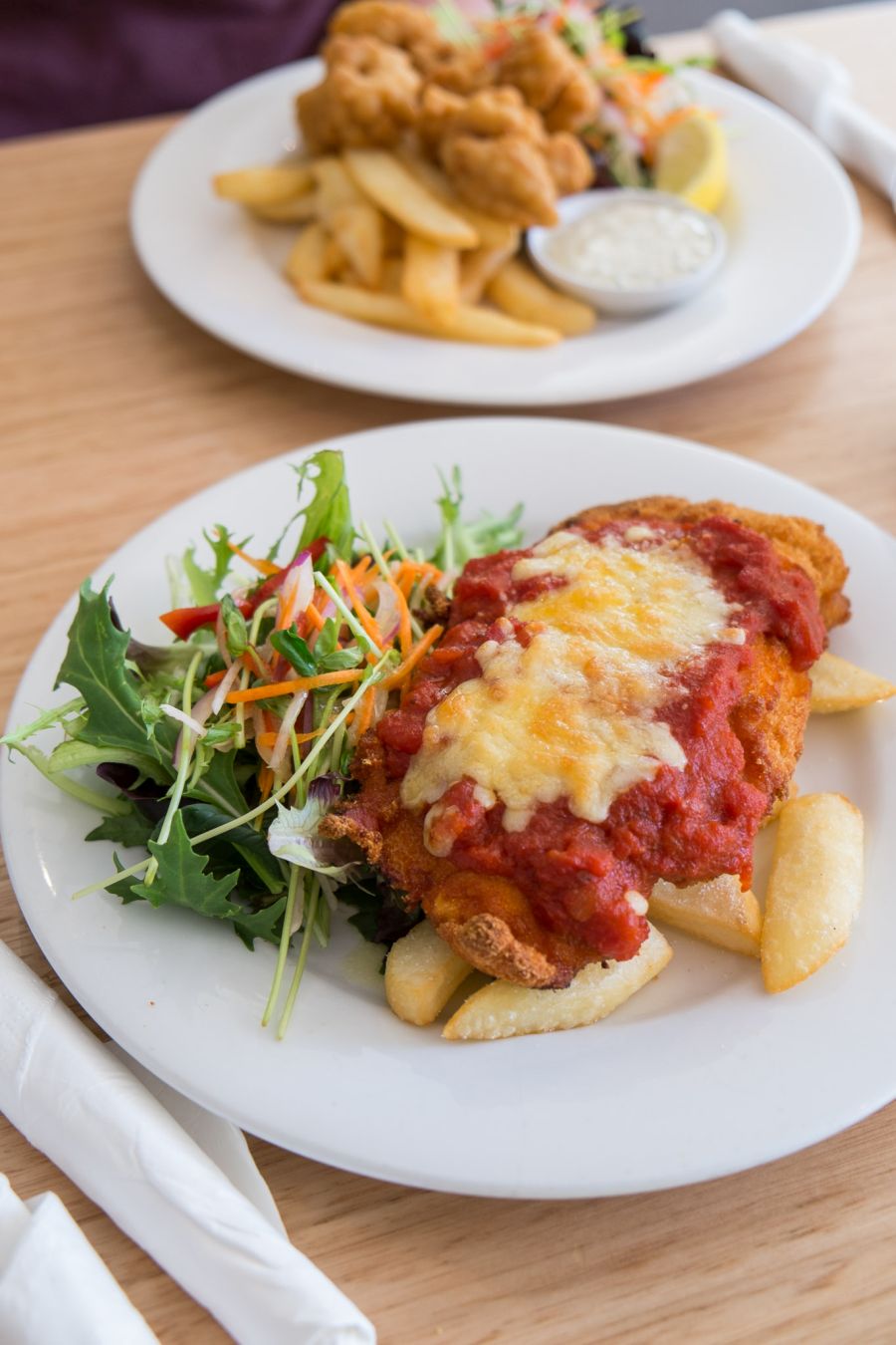 Chicken parmigiana with chunky chips and salad (AU$15 - tour menu)