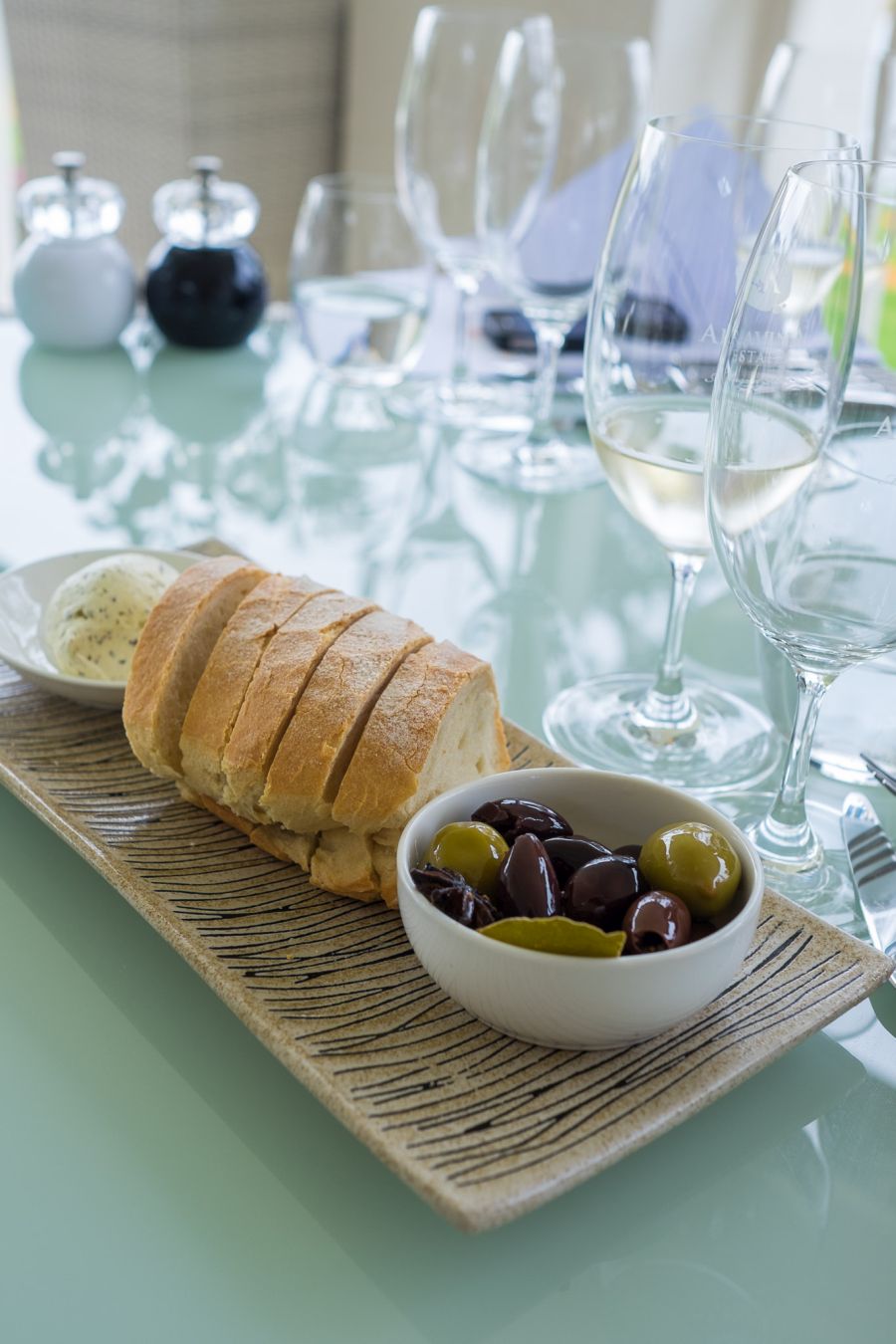 Marinated olives, freshly baked Aravina Estate bread, and whipped truffle butter