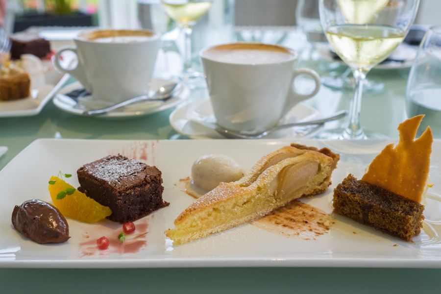 Dessert tasting plate: L-R: flourless chocolate cake with chocolate marquise; pear and frangipane tart and honey semi freddo ; spice cake with ginger syrup and ginger tuille