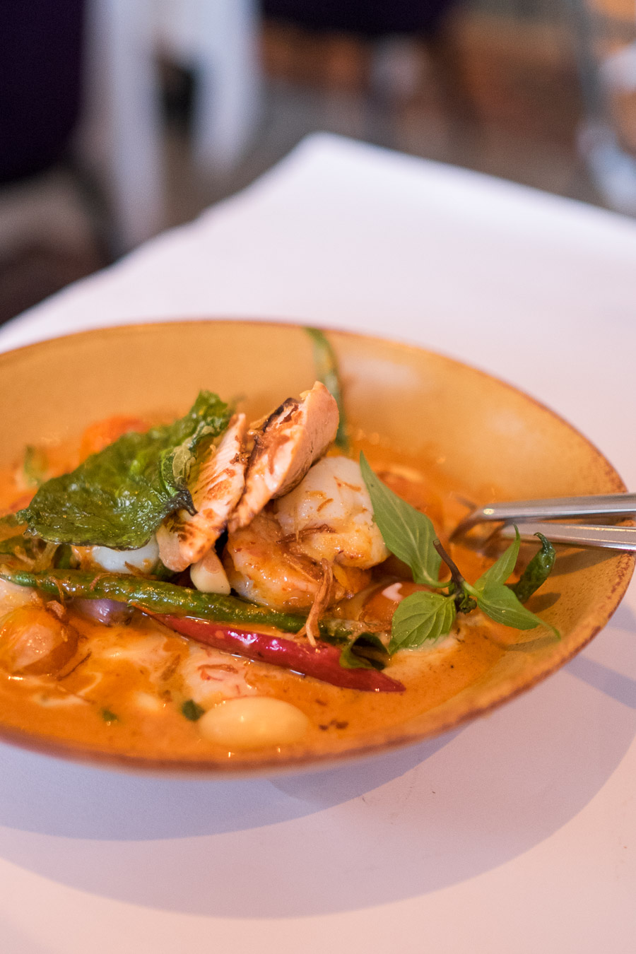 Red curry of fish fillet, prawns and scallops, bean, cherry tomato, pickled garlic and Thai basil