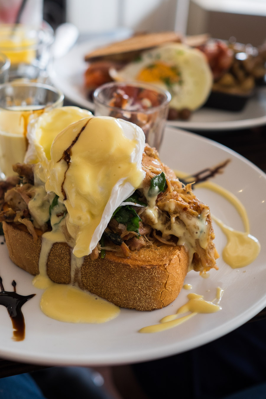 Pulled pork Benedict with two poached eggs, wilted spinach, onion jam, hollandaise and thick toast (AU$19.50)