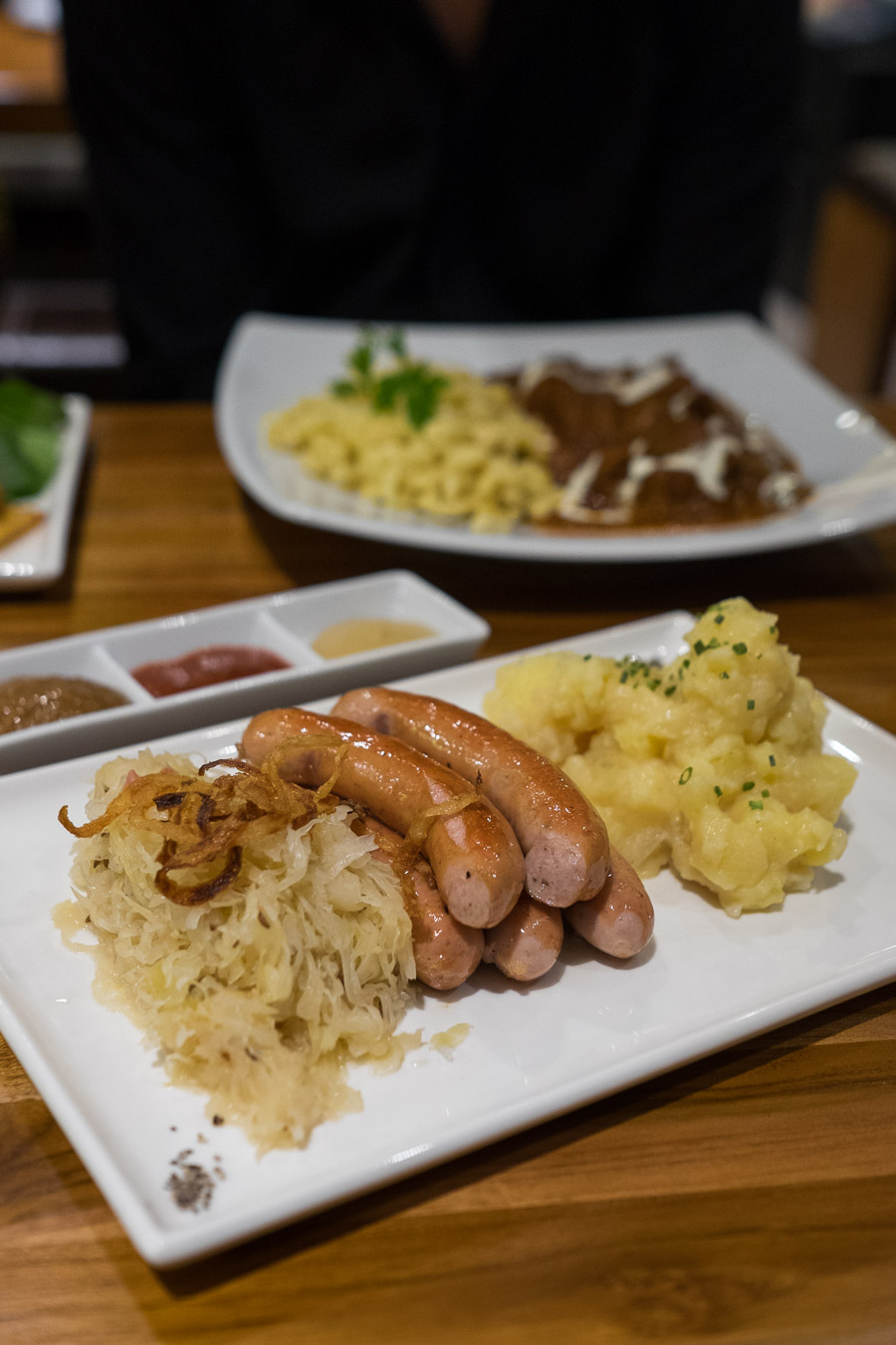 Pork sausages with sauerkraut and potato salad
